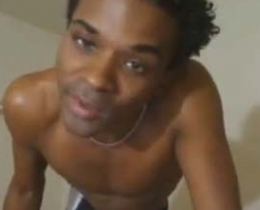 Black gay guy striping in front of webcam